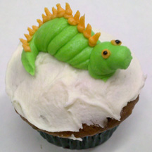 Dragon party cupcake with green dragon in frosting