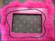 picture frame with pink boa and beads